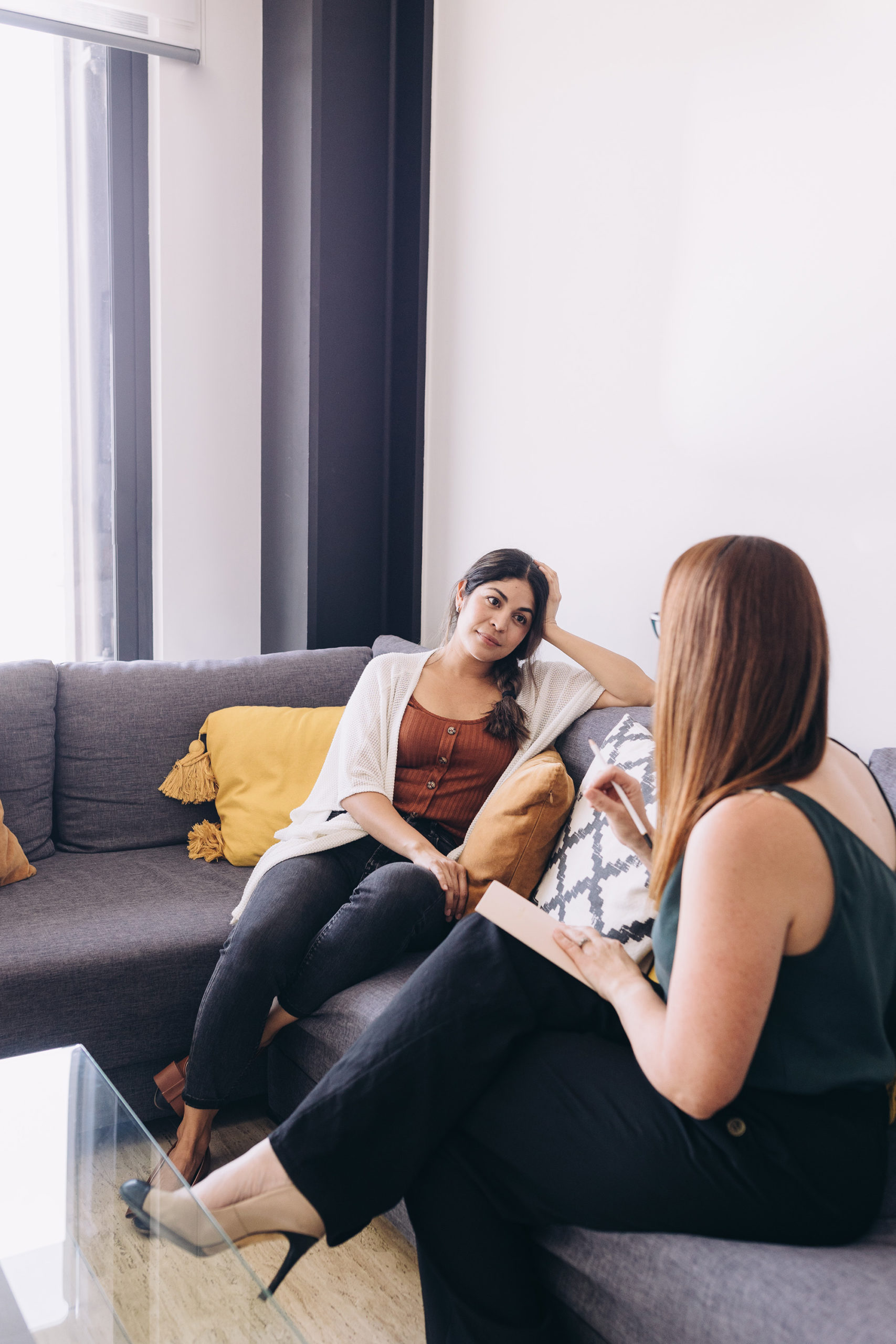 Women talking on couch during counseling session